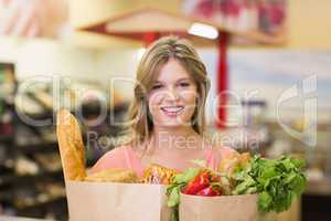 Portrait of smiling pretty blonde woman buying food products