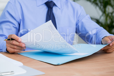 Businessman reading a contract before signing it