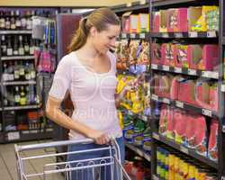 Pretty woman picking product in shelf