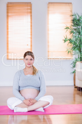 Pregnant woman looking at camera