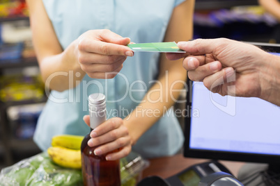 Woman at cash register paying with credit card