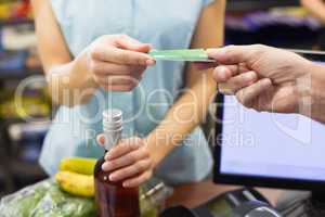 Woman at cash register paying with credit card