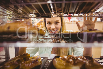 Portrait of a woman looking at new plates with pastries