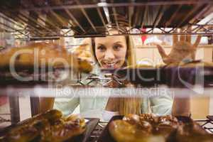 Portrait of a woman looking at new plates with pastries