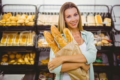 A woman buying bread in the pastries shelf