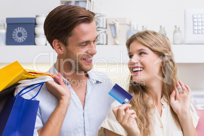 Portrait of a happy couple showing their new credit card