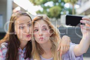 Happy women friends taking a selfie