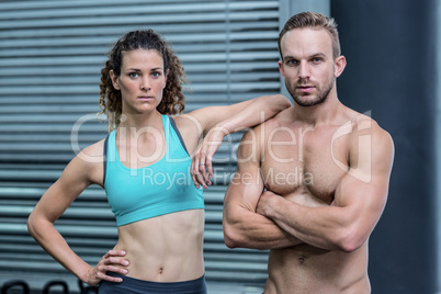 Attentive muscular couple looking at the camera