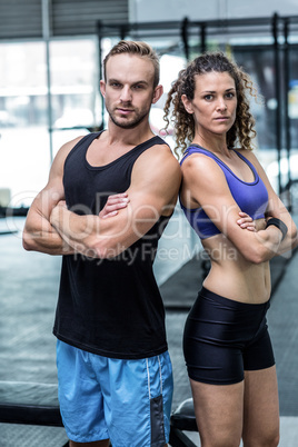 Muscular couple looking at the camera Muscular couple looking at the camera