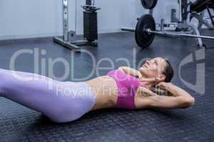 Muscular woman doing abdominal crunch