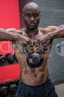 Portrait of muscular man lifting a kettlebell