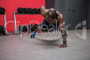 Young Bodybuilder doing One-armed push ups