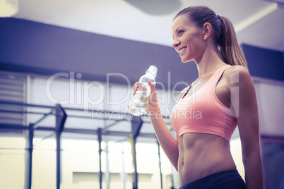 Young smiling Woman holding a bottle of water