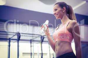 Young smiling Woman holding a bottle of water