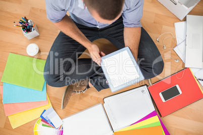 Young creative businessman working on tablet