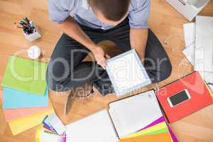 Young creative businessman working on tablet