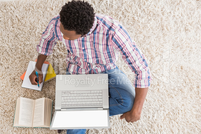 Young businessman writing on paper in the office