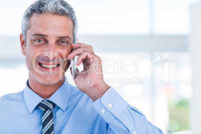 Happy businessman having a phone call