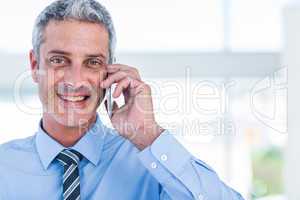 Happy businessman having a phone call