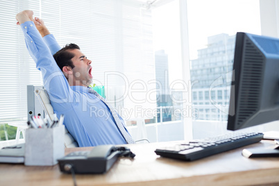 Businessman yawning and stretching