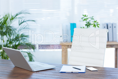 Business desk with laptop and notebook