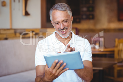 Casual man using his tablet