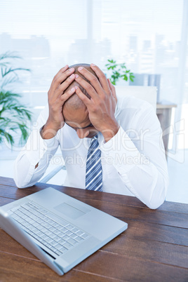 Anxious businessman with head in hands Anxious businessman with head in hands