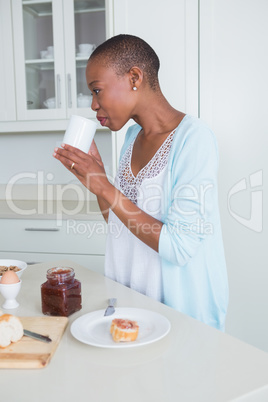 Beautiful woman drinking a glass of milk