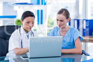 Doctor and nurse looking at laptop