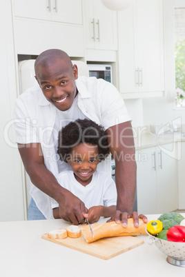 Little boy cooking with his father