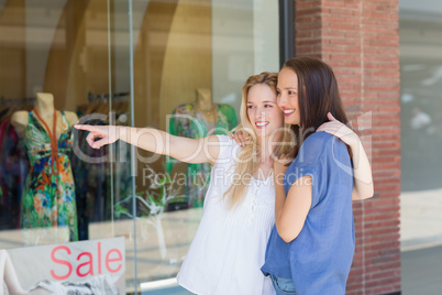 Smiling girl friends with arms around