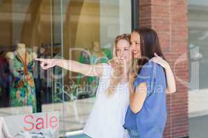 Smiling girl friends with arms around