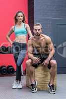 Standing and sitting muscular couple