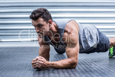 A muscular man on plank position