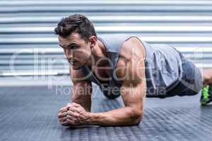 A muscular man on plank position