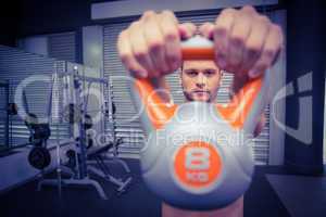 Muscular man lifting a kettlebell