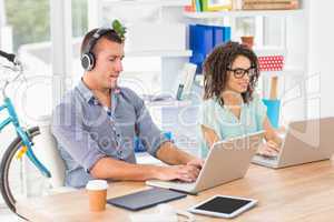 Relaxed business colleagues working on laptop