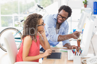 Two creative business colleagues working on the computer