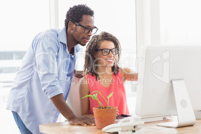 Two creative business colleagues working on the computer