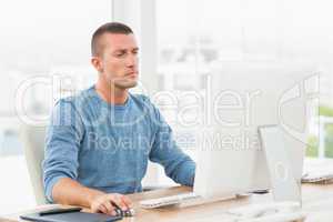 Young creative businessman working on the computer