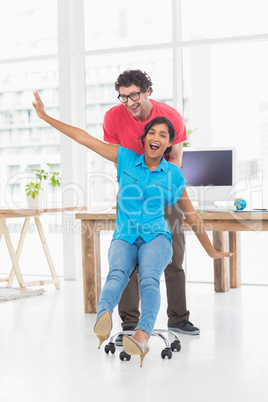 Smiling partners playing together with swivel chair