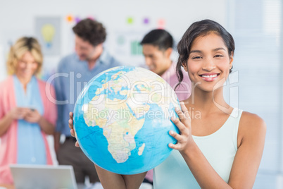 Casual woman holding a globe