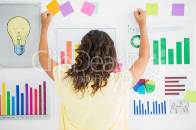 Young businesswoman facing the wall