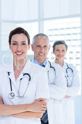 Portrait of three smiling medical colleagues with arms crossed