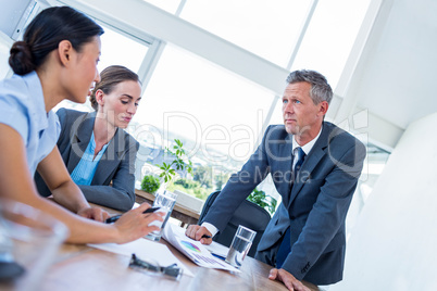 Business people speaking together during meeting