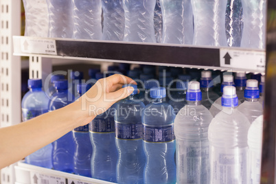 A woman taking a water bottle