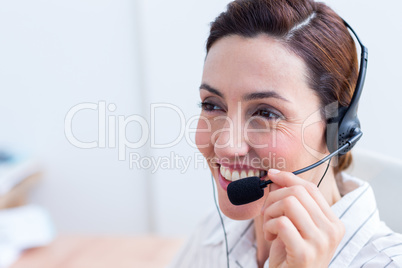 Brunette smiling using headphone