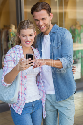 Happy couple looking at smartphone