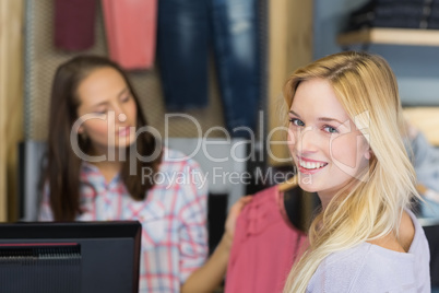 Smiling blonde doing shopping and looking at camera