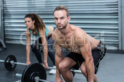 Muscular couple lifting weight together Muscular couple lifting weight together